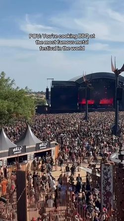 Large crowd attending a metal festival near MELT DELI Les halles barbecue stand under clear blue sky.