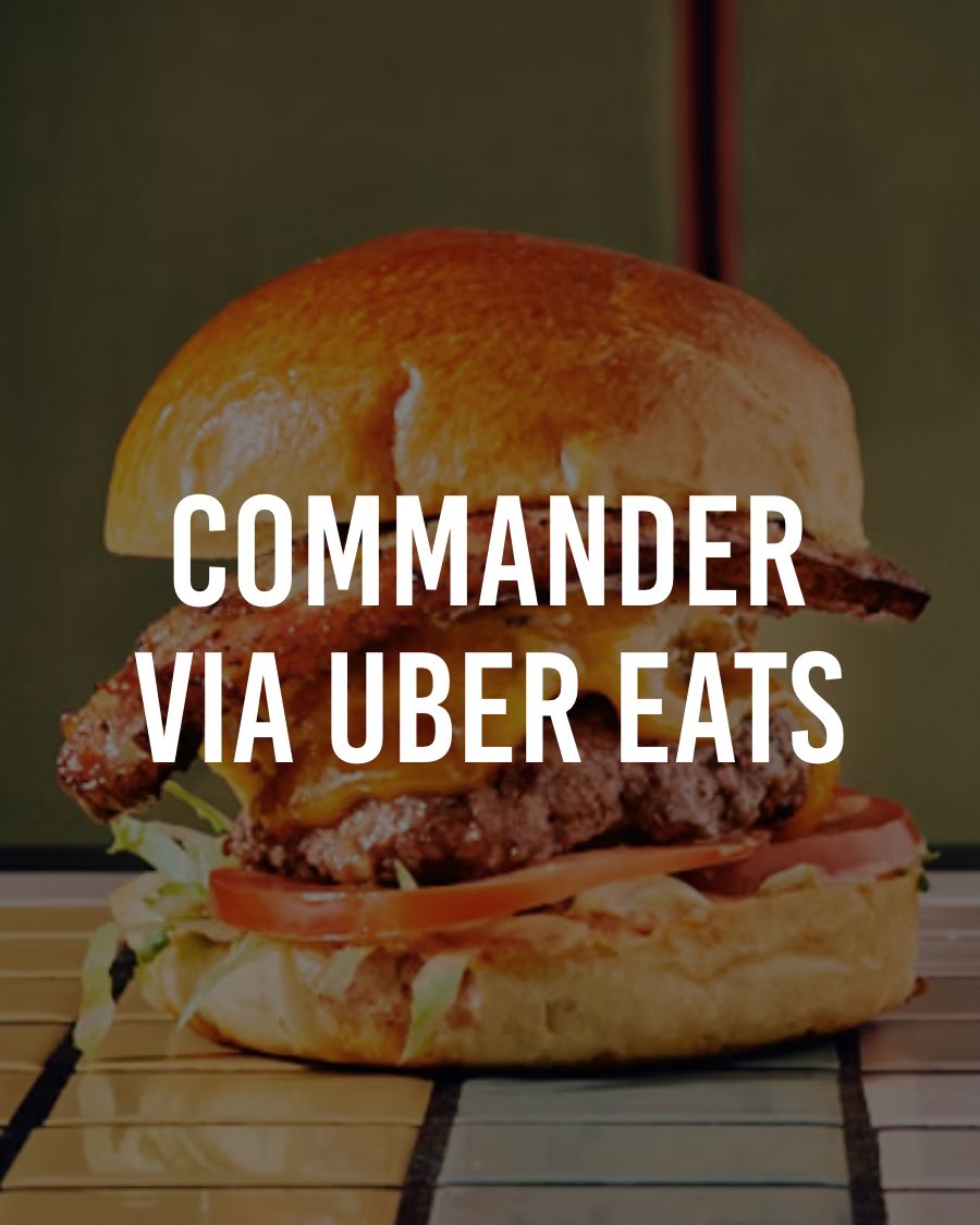 Pulled pork dish topped with sliced green onions, served in a white bowl.