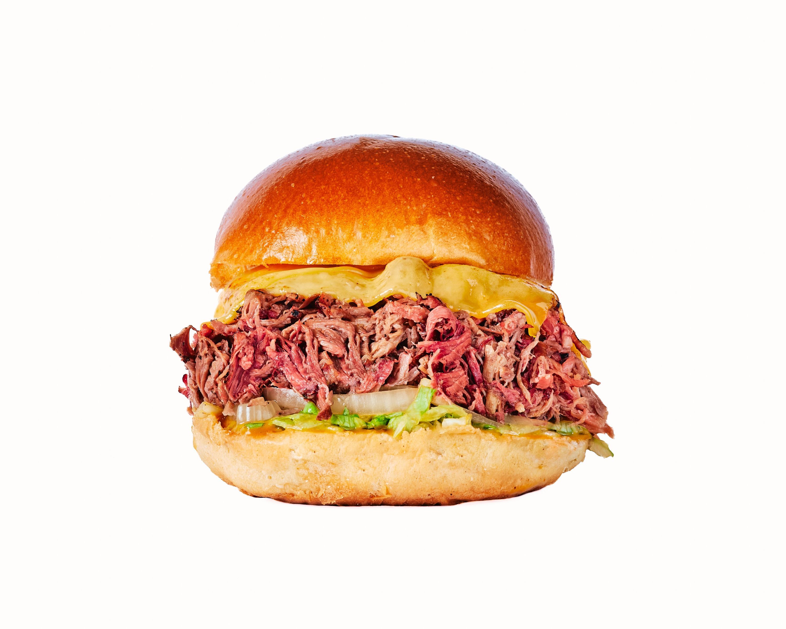 Sign featuring a delicious sandwich with brisket, alongside another appetizing burger, highlighting their barbecue offerings.